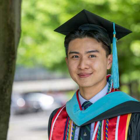 Sloan student Jacky in cap in gown during graduation