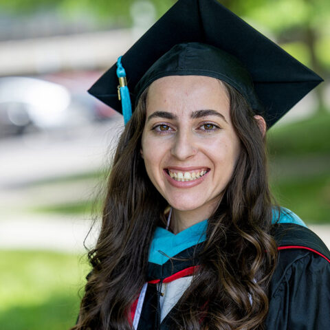 MPA alumni wearing graduation cap and gown