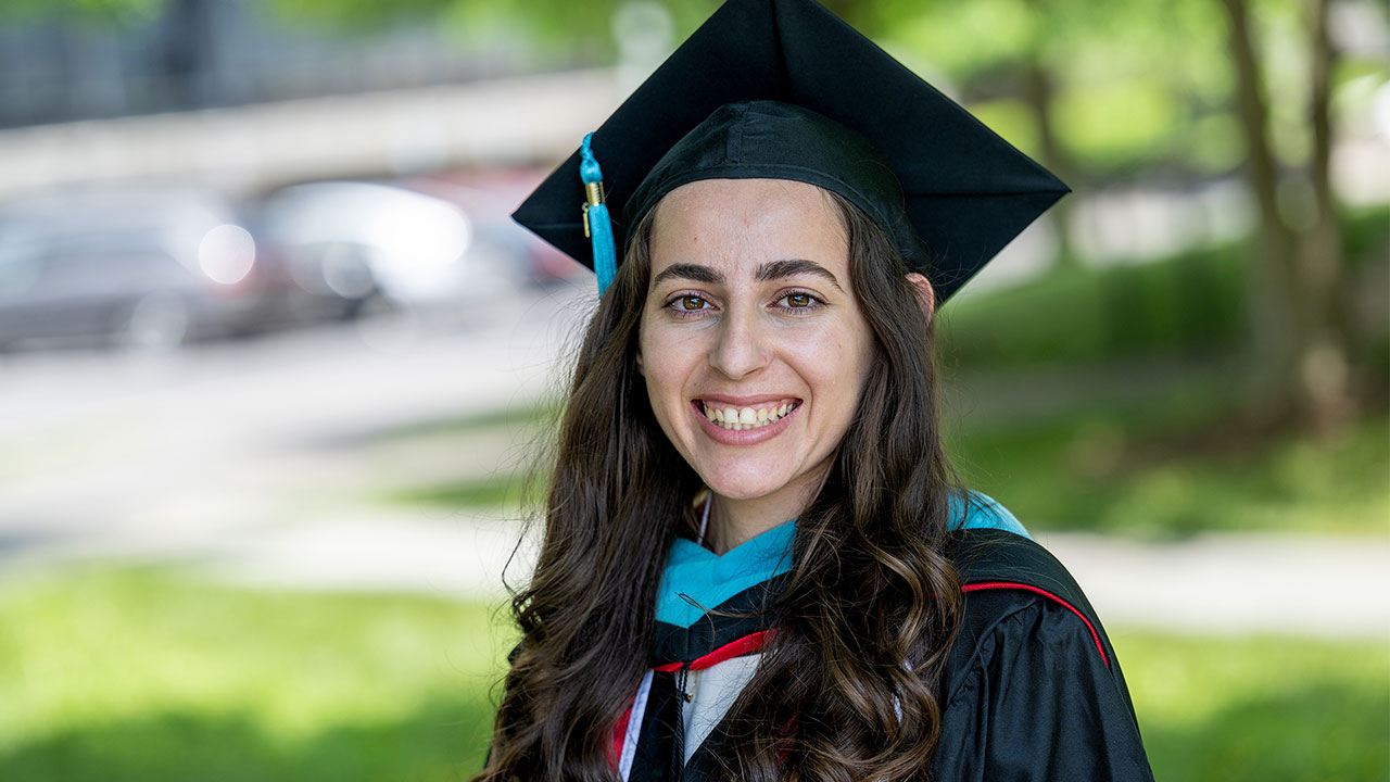 MPA alumni wearing graduation cap and gown