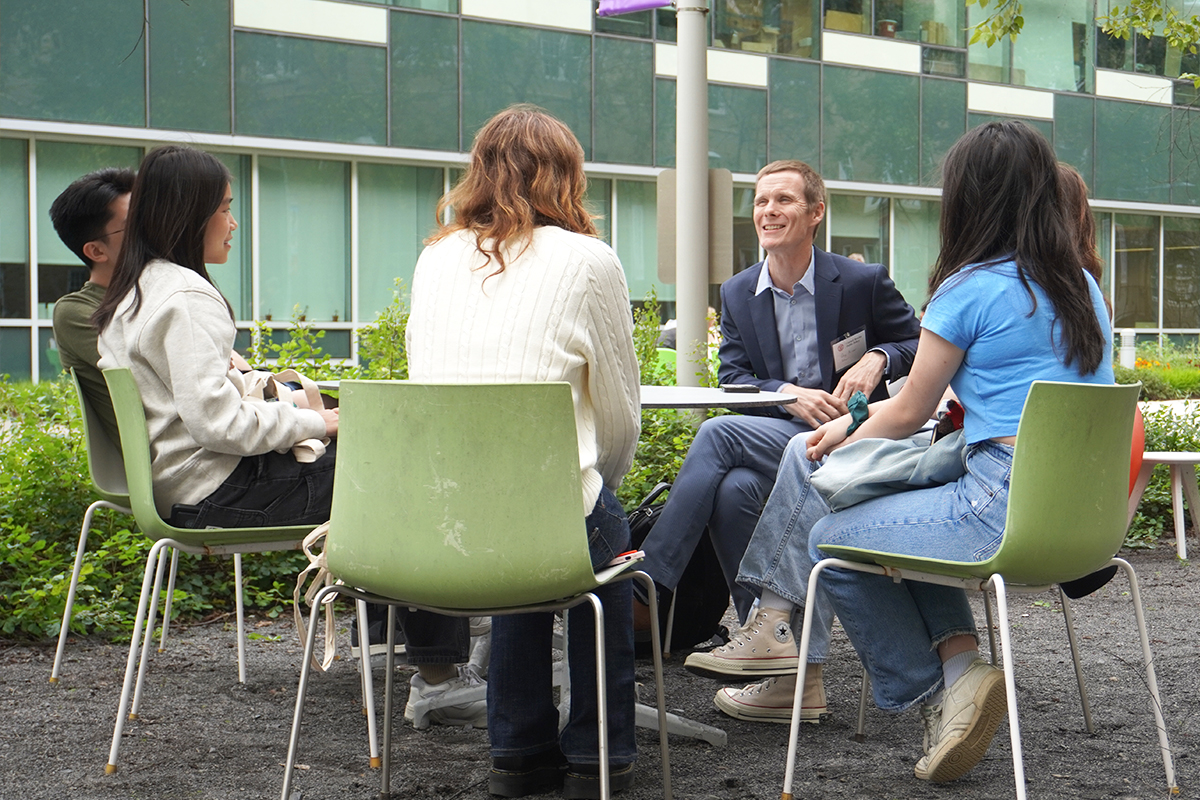 Students meet outside with Professor Kriner. 