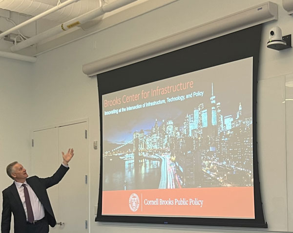 Rick Geddes presenting in front of a screen that says Brooks Center on Infrastructure
