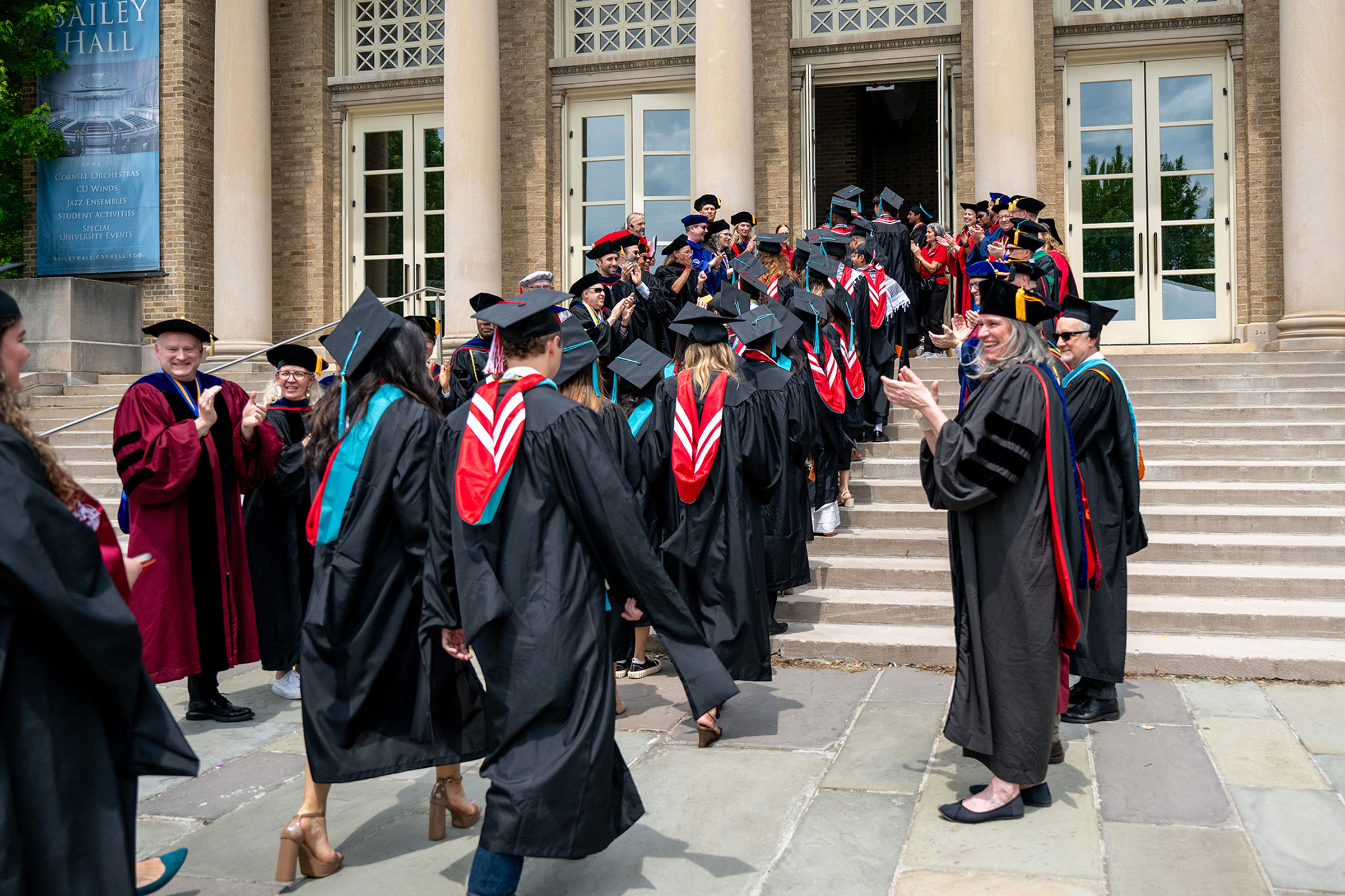 Brooks faculty clapping and congratulating Brooks School graduates