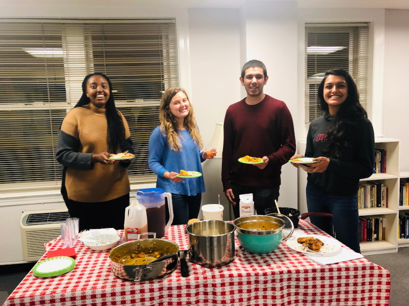 Students dining together during a CIW potluck