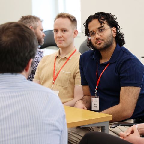 Two students talking with a professor