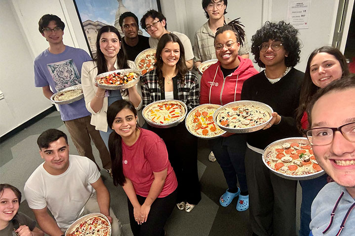 Group of students making pizza together