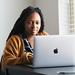 Woman sitting in front of a lap top