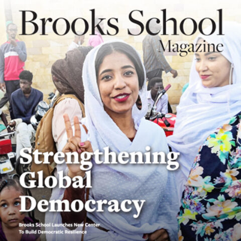 Cover of Brooks School magazine featuring a woman protesting in Sudan. 