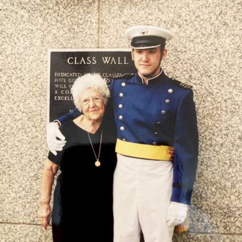 Man in military uniform standing next to his grandmother