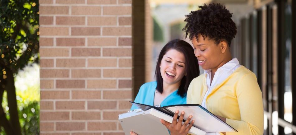 health care professionals reviewing documents while standing outside