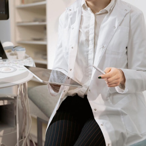 A healthcare professional in a lab using a tablet