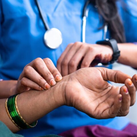 Woman taking pulse