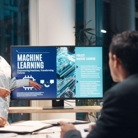 Group of people in a conference room discussing a presentation on AI