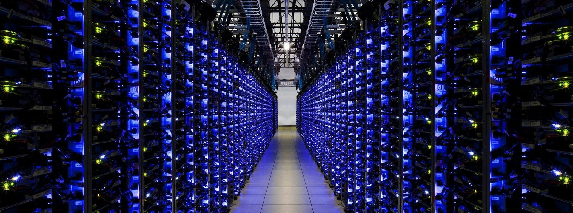 An aisle of servers with bright blue lights