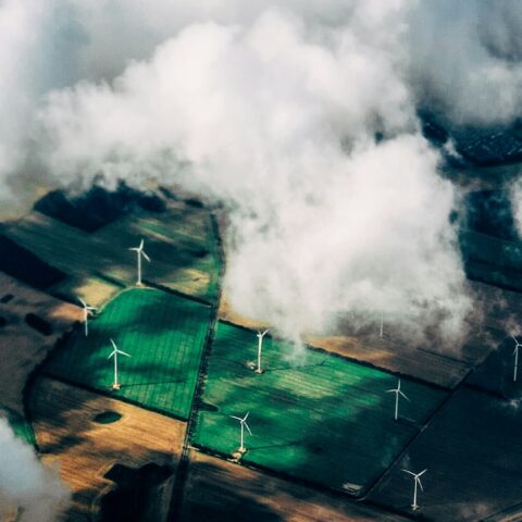 aerial photo of wind turbines near field