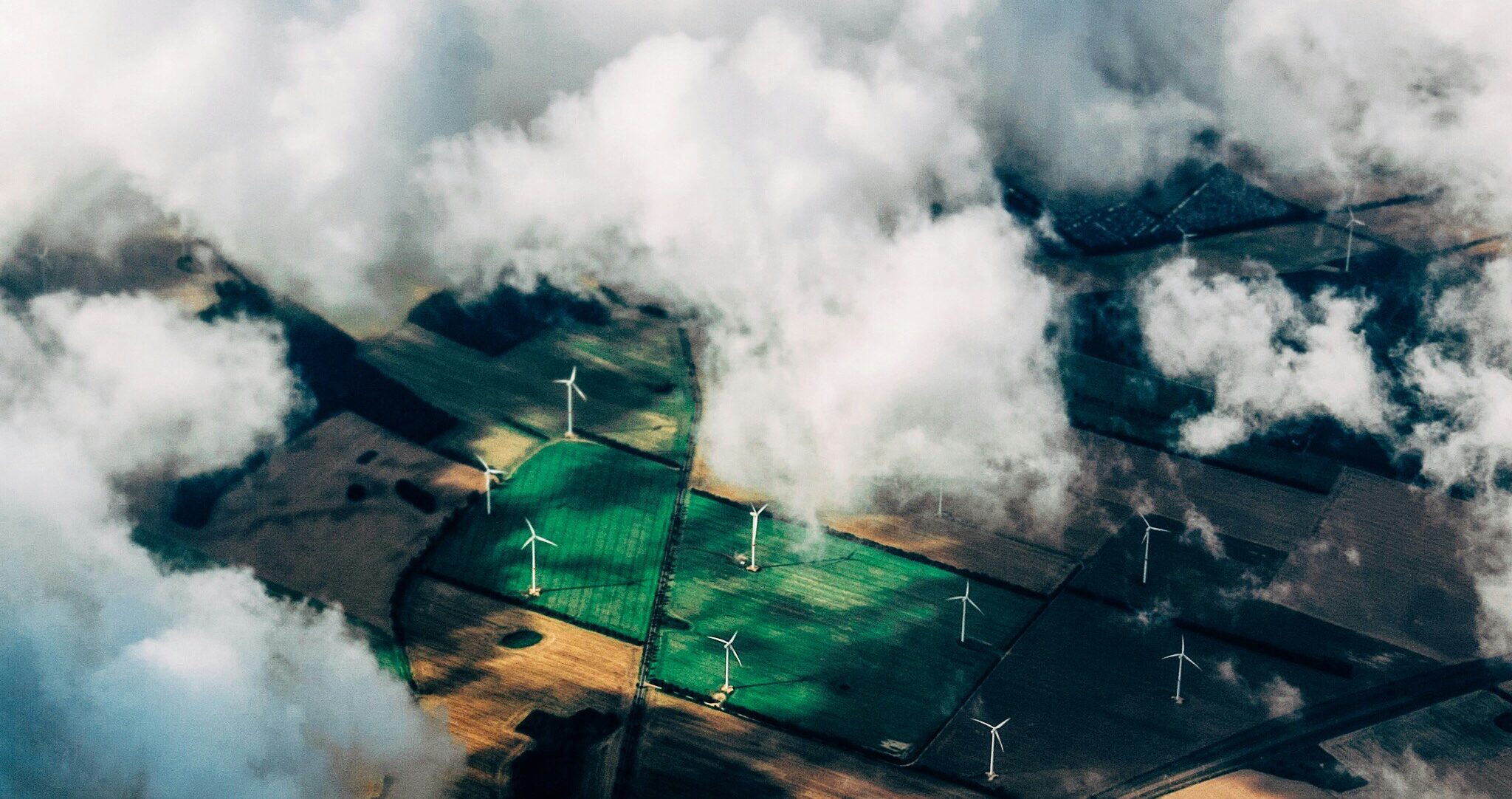 aerial photo of wind turbines near field