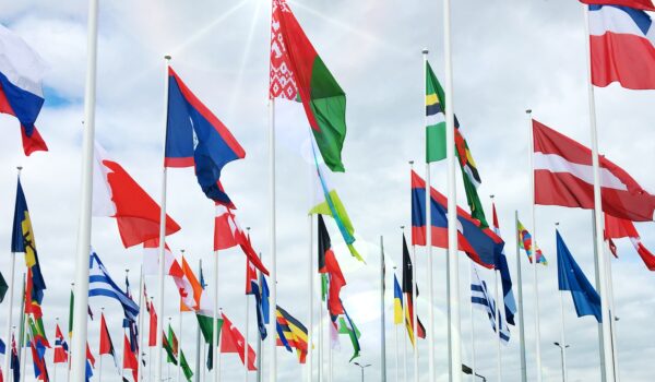 Multiple countries flags with blue sky behind